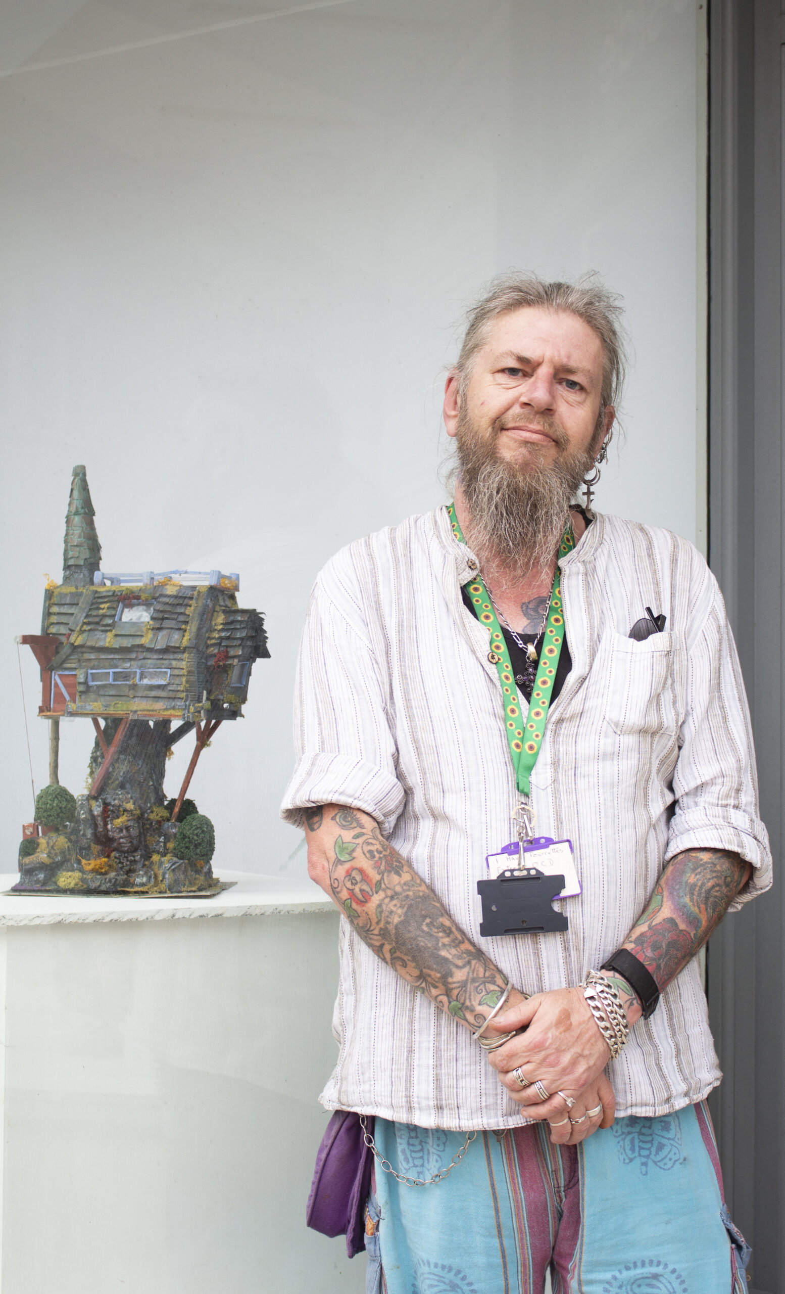 Man standing next to a model house